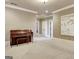 A carpeted bonus room includes a piano and neutral decor at 550 Wentworth Ct, Fayetteville, GA 30215