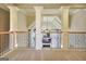 An upper floor living room with columns showcases a view of the lower floor and fireplace at 550 Wentworth Ct, Fayetteville, GA 30215
