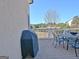Outdoor deck area features metal table and chairs, overlooking wooded scenery and neighborhood at 550 Wentworth Ct, Fayetteville, GA 30215