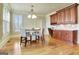Charming dining area with wood floors, stylish light fixture, and elegant shutters at 550 Wentworth Ct, Fayetteville, GA 30215