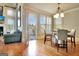 Dining area with modern lighting, a table set for four, and a door to the deck at 550 Wentworth Ct, Fayetteville, GA 30215
