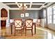 Elegant dining room featuring coffered ceilings, wainscoting, hardwood floors, and sophisticated chandelier at 550 Wentworth Ct, Fayetteville, GA 30215