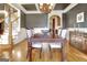 Formal dining area displaying coffered ceilings, dark walls, hardwood floors and access to a stairway at 550 Wentworth Ct, Fayetteville, GA 30215