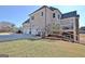 Spacious home featuring a three-car garage and a deck, set against a lush green yard at 550 Wentworth Ct, Fayetteville, GA 30215