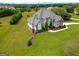 Stately home showcasing manicured front lawn, lush landscaping, and charming architectural details at 550 Wentworth Ct, Fayetteville, GA 30215