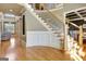 Elegant foyer with a curved staircase, hardwood floors, and stylish decor, creating a welcoming atmosphere at 550 Wentworth Ct, Fayetteville, GA 30215