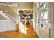 Grand foyer view showcasing wood floors, stairs with iron spindles, and an entry to dining room at 550 Wentworth Ct, Fayetteville, GA 30215