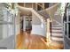 Bright, open foyer with hardwood floors and a curved staircase, showcasing the home's elegant design at 550 Wentworth Ct, Fayetteville, GA 30215