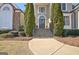 Charming home entrance with stone steps, decorative columns, and manicured landscaping at 550 Wentworth Ct, Fayetteville, GA 30215