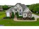 An aerial view of a beautiful two-story home with manicured lawns and mature landscaping at 550 Wentworth Ct, Fayetteville, GA 30215