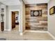 Hallway leads to game room with unique wood accent wall and space for entertainment at 550 Wentworth Ct, Fayetteville, GA 30215