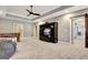 Open game room with a foosball table, TV entertainment center, and sliding barn door at 550 Wentworth Ct, Fayetteville, GA 30215