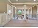 An upper-level hallway showcases architectural columns, carpet, and a wrought iron stair railing at 550 Wentworth Ct, Fayetteville, GA 30215