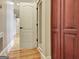 Bright hallway with hardwood floors, white trim, and closet doors at 550 Wentworth Ct, Fayetteville, GA 30215