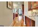 Kitchen hallway boasts granite counters and custom cabinets leading to a sunlit living room at 550 Wentworth Ct, Fayetteville, GA 30215