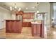 Elegant kitchen with wooden cabinets, stainless steel appliances, and center island with seating at 550 Wentworth Ct, Fayetteville, GA 30215