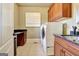 Well-equipped laundry room with modern appliances and ample cabinet space and granite countertops at 550 Wentworth Ct, Fayetteville, GA 30215