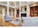 Open-concept living room with a fireplace and detailed trim work at 550 Wentworth Ct, Fayetteville, GA 30215