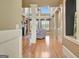 Bright living room with hardwood floors, fireplace, and large windows with plantation shutters at 550 Wentworth Ct, Fayetteville, GA 30215