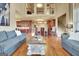 Open-concept living room boasts hardwood floors, a staircase, and a view into the modern kitchen at 550 Wentworth Ct, Fayetteville, GA 30215