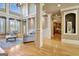 Open living room featuring a fireplace, large windows with shutters, and hardwood flooring at 550 Wentworth Ct, Fayetteville, GA 30215