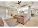 Open living room featuring a sectional sofa, hardwood floors, and view of the kitchen at 550 Wentworth Ct, Fayetteville, GA 30215