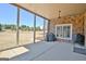 This covered patio includes two grills and views of the large manicured backyard at 550 Wentworth Ct, Fayetteville, GA 30215