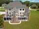 Aerial view of the backyard features large decks, stone accents and well-maintained lawn at 550 Wentworth Ct, Fayetteville, GA 30215