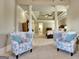 Sitting room has a view into the bedroom and a sitting area with chairs and columns at 550 Wentworth Ct, Fayetteville, GA 30215