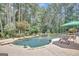 Lush backyard pool with a waterfall feature, surrounded by trees and patio space at 135 Hayden Ct, Fayetteville, GA 30215