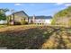 Expansive backyard showing the home's exterior, patio area, and lush green lawn at 333/337 Old Carrollton Rd, Roopville, GA 30170