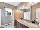 Bathroom with a double sink vanity, ample lighting, and neutral tones at 333/337 Old Carrollton Rd, Roopville, GA 30170