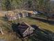 Aerial view of the property showcasing the house and outbuildings nestled amongst mature trees and green spaces at 8380 Cedar Grove & 8400 Teal Road Rd, Fairburn, GA 30213