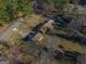 Aerial view showcasing the house, back deck, outbuildings and wooded surroundings at 8380 Cedar Grove & 8400 Teal Road Rd, Fairburn, GA 30213