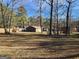 Picturesque backyard featuring a home, shed, and mature trees, offering a peaceful and private outdoor space at 8380 Cedar Grove & 8400 Teal Road Rd, Fairburn, GA 30213