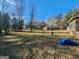 Expansive backyard featuring a shed, blue tarp, and ample space for outdoor activities and relaxation at 8380 Cedar Grove & 8400 Teal Road Rd, Fairburn, GA 30213