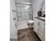 Bathroom with a shower, modern vanity with sink, and wood look vinyl flooring at 8380 Cedar Grove & 8400 Teal Road Rd, Fairburn, GA 30213