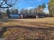 Charming single-story home with a large front yard, detached garage and carport surrounded by mature trees at 8380 Cedar Grove & 8400 Teal Road Rd, Fairburn, GA 30213