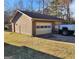 Detached garage with white doors and brown siding, and adjacent parking at 8380 Cedar Grove & 8400 Teal Road Rd, Fairburn, GA 30213