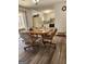 Dining area open to the kitchen with wood-look floors and an exterior door leading to the sunroom at 8380 Cedar Grove & 8400 Teal Road Rd, Fairburn, GA 30213