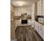 Bright kitchen with white cabinets, laminate countertops, and stainless steel appliances at 8380 Cedar Grove & 8400 Teal Road Rd, Fairburn, GA 30213