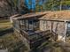 An exterior shot of the large back deck, screened in porch, and rear of the home at 8380 Cedar Grove & 8400 Teal Road Rd, Fairburn, GA 30213