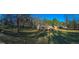 Panoramic view showcasing a house and an outbuilding set within an expansive, tree-lined yard at 8380 Cedar Grove & 8400 Teal Road Rd, Fairburn, GA 30213