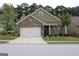 Charming one-story home featuring a brick facade, attached two-car garage, and manicured front lawn at 2297 Knob Creek Dr, Snellville, GA 30078