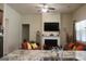 Bright open-concept living room featuring a fireplace, TV, and a glimpse of the kitchen at 2297 Knob Creek Dr, Snellville, GA 30078