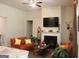 Spacious living room with a fireplace, ceiling fan, mounted television and comfortable seating at 2297 Knob Creek Dr, Snellville, GA 30078