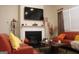 Comfortable living room featuring a fireplace, mantle, mounted TV, and two plush sofas at 2297 Knob Creek Dr, Snellville, GA 30078