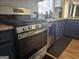 A modern kitchen with stainless steel appliances, and white cabinets providing a clean and functional cooking space at 6558 Eastbriar Dr, Lithonia, GA 30058