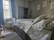 Comfortable bedroom featuring natural light, a queen bed and warm, inviting textures at 6558 Eastbriar Dr, Lithonia, GA 30058