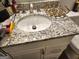 Modern bathroom with granite countertops, updated hardware, and under-sink cabinet storage at 6558 Eastbriar Dr, Lithonia, GA 30058